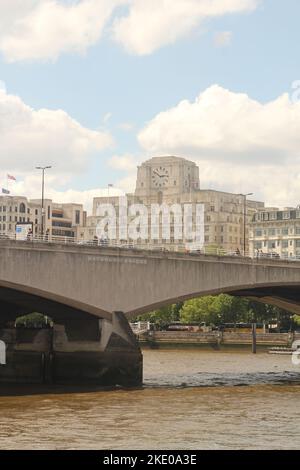 A vertical shot of the Waterloo Bridge in front of the Shell Mex House, London, United Kingdom Stock Photo