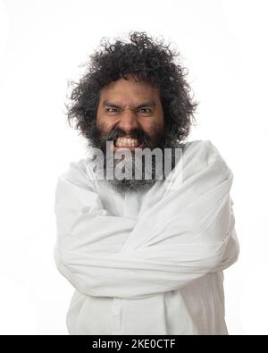 A vertical shot of a psychopath going crazy with rage in a straitjacket