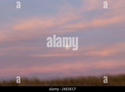 full moon at sunset in Amagansett, NY Stock Photo