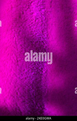 Tree branch shadow falls on pink furry fabric background Stock Photo
