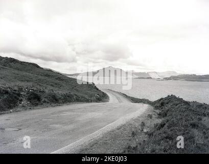 1960s, historical, coastal road by lock, Scottish Highland, England, UK. Stock Photo