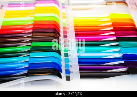 a group multi-colored plastic ballpoint pens on white table Stock Photo