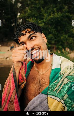 Smiling man looking away wearing towel Stock Photo