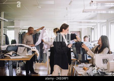 Fashion designers working together at workshop Stock Photo