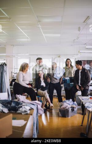 Happy male and female fashion designers enjoying at workshop Stock Photo