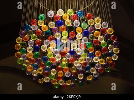 SELESTAT, FRANCE - DECEMBER 20, 2015: Christmas decoration (chandelier made of colorful Christmas balls) in St. Foy Church. Stock Photo