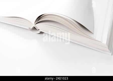 close-up view of blank page open hardback book on white desk Stock Photo