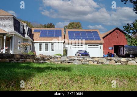 South Woodstock, Connecticut, USA. Solar panels installed in the roof of a garage and breezeway structure at a rural home. Stock Photo