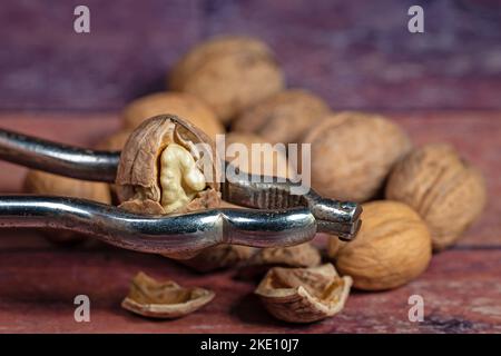 Walnuts and nutcracker in a close-up Stock Photo