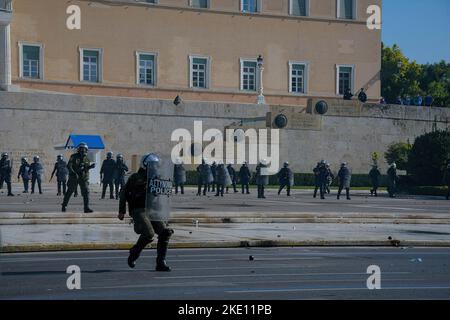 Athens, Greece. 09th Nov, 2022. A riot policeman retreats after throwing teargas canister towards the protesters at Syntagma Square during the demonstration. Anarchists clash with riot police in front of the Greek parliament during a national workers strike. Credit: SOPA Images Limited/Alamy Live News Stock Photo