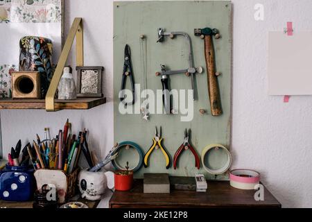 Work tools and equipment hanging on board by wall Stock Photo