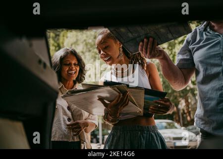 Women discussing with each other holding vinyl records Stock Photo