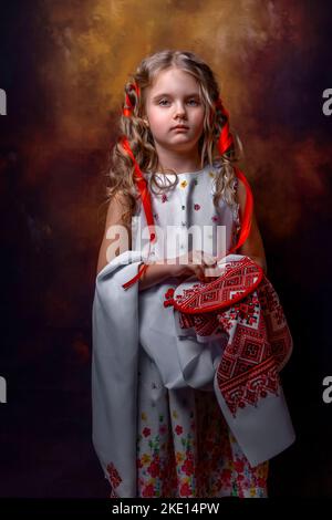 a girl in a national Ukrainian costume embroiders Stock Photo