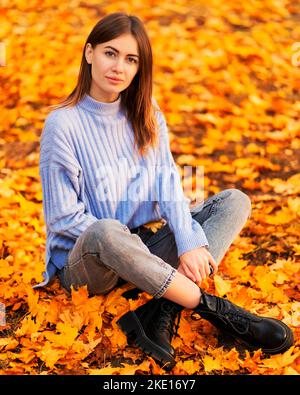 Beautiful girl with leaves on an sunny autumn-day in park Stock Photo ...