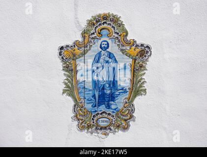 Saint Isidore, decorative ceramic tiles with blue and golden colors in Portugal Stock Photo