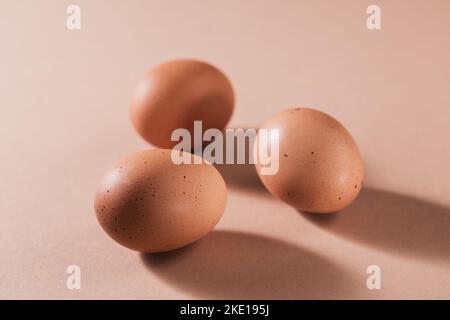 Chicken brown eggs on beige background. Stock Photo