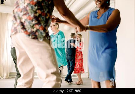 Senior couple enjoying while dancing in class Stock Photo