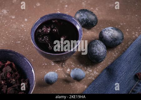 Process of dyeing eggs with natural paints for Easter. Stock Photo