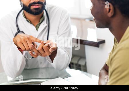 doctor and male patient talking at office consultation for further treatment Stock Photo