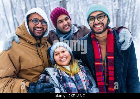 four people taking selfie shot outdoors at new year holidays Stock Photo