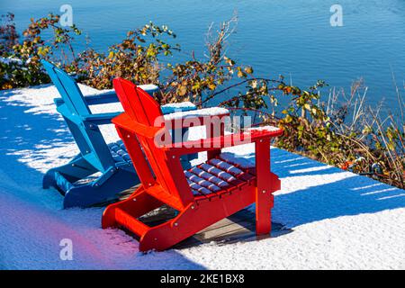 Blue and Red chairs with a light covering of snow in Richmond British Columbia Canada Stock Photo