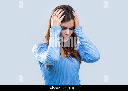 Woman suffering from headache desperate, stressed because pain and migraine. Woman with hard headache holding hands on head. Brunette woman touching Stock Photo
