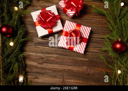 three Christmas boxes on a wooden background . photo with a copy-space. Stock Photo