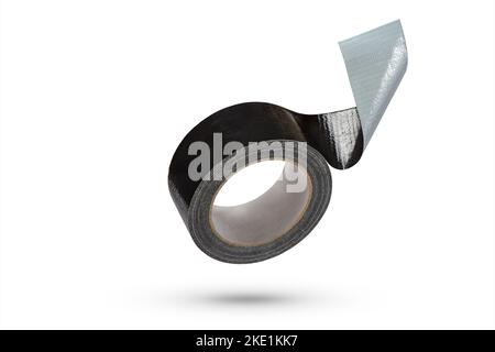 Roll of black adhesive tape isolated on white background. Reinforced black duct tape falls, casting a shadow. Unwound roll of electrical tape. Stock Photo