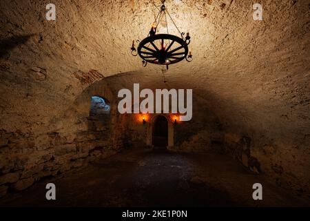 The dark tunnel in the catacomb of Pidhirtsi Castle, Lviv region, Ukraine. Stock Photo