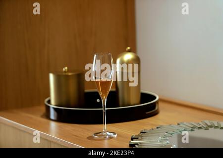 glass with champagne in wooden cabinet Stock Photo