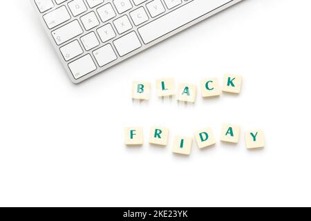 Black friday text and computer keyboard isolated on the white background. Stock Photo