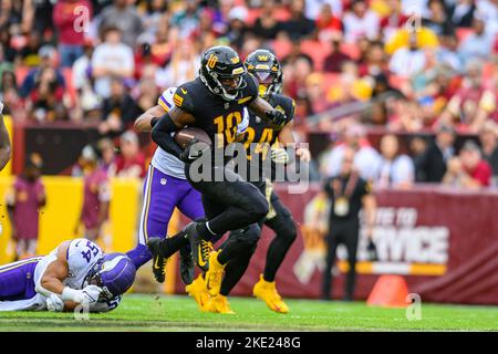 Washington Commanders wide receiver Curtis Samuel (10) is taken down by  Philadelphia Eagles safety Marcus Epps (22) during the second half of an  NFL football game, Sunday, Sept. 25, 2022, in Landover