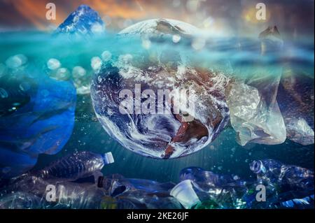 The world floats in the ocean amidst the plastic. Earh provided by NASA Stock Photo