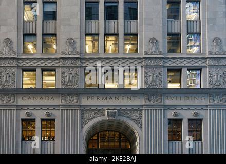 Toronto, Canada - November 2022:  Close-up view of the ornate stone decorations on a bank building in Toronto's financial district on Bay Street, cons Stock Photo