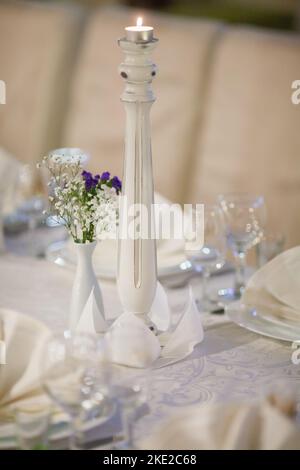 Decorated plate with fork and spoon. Table set up in boho style with pampas grass and greenery Stock Photo