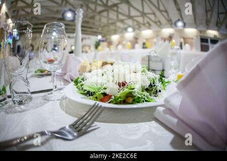 Decorated plate with fork and spoon. Table set up in boho style with pampas grass and greenery Stock Photo