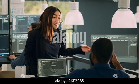 Database admins doing highfive gesture to celebrate coding achievement, enjoying successful source code development. Working on cloud computing program with html script. Handheld shot. Stock Photo