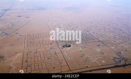 DUBAI, UNITED ARAB EMIRATES, UAE - NOVEMBER 20, 2017: top view on Dubai and its surroundings, traffic of highway from airplane at sunset, views of Dubai on arrival at airport . High quality photo Stock Photo