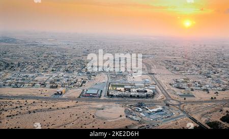 DUBAI, UNITED ARAB EMIRATES, UAE - NOVEMBER 20, 2017: top view on Dubai and its surroundings, traffic of highway from airplane at sunset, views of Dubai on arrival at airport . High quality photo Stock Photo