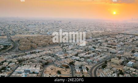 DUBAI, UNITED ARAB EMIRATES, UAE - NOVEMBER 20, 2017: top view on Dubai and its surroundings, traffic of highway from airplane at sunset, views of Dubai on arrival at airport . High quality photo Stock Photo