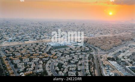 DUBAI, UNITED ARAB EMIRATES, UAE - NOVEMBER 20, 2017: top view on Dubai and its surroundings, traffic of highway from airplane at sunset, views of Dubai on arrival at airport . High quality photo Stock Photo