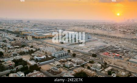 DUBAI, UNITED ARAB EMIRATES, UAE - NOVEMBER 20, 2017: top view on Dubai and its surroundings, traffic of highway from airplane at sunset, views of Dubai on arrival at airport . High quality photo Stock Photo