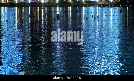 DUBAI, UNITED ARAB EMIRATES, UAE - NOVEMBER 20, 2017: Night Dancing fountain does not work, it is off, night view, close-up, in the water reflect skyscrapers. High quality photo Stock Photo