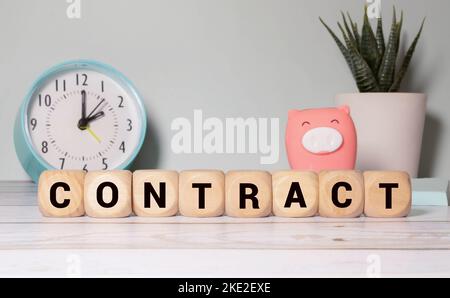 On a light background on wooden cubes the word CONTRACT is written. Business concept. Stock Photo