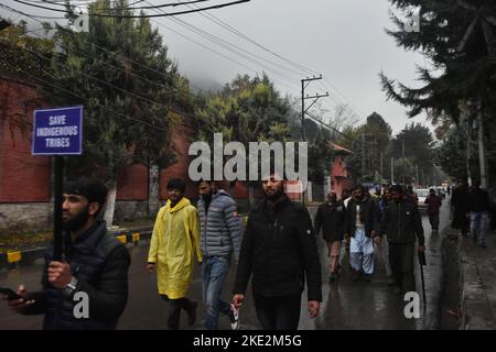 November 9, 2022, Srinagar, Jammu and Kashmir, India: Hundreds of Gujjar and Bakerwal members holding placards, amid heavy rains and bone-chilling cold, started a foot march from the outskirts of Srinagar towards the press enclave on Tuesday against the National Commission of Schedule Tribes. The agitated protesters told they have launched protests across Jammu and Kashmir after the National Commission for Scheduled Tribes (NCST) cleared the way for the inclusion of the Pahari group in the Scheduled Tribes list. The Gujjar community members allege that Pahari's inclusion in the ST list will Stock Photo