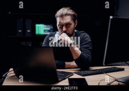 Computer hacker at dark room Stock Photo