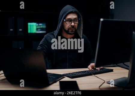 Hacker working on computer Stock Photo