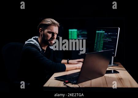 Programmer hacking on computers Stock Photo