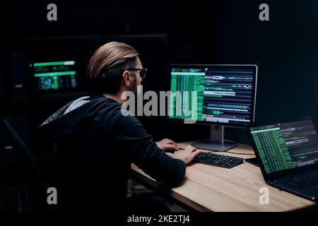 Professional hacker working on computer Stock Photo
