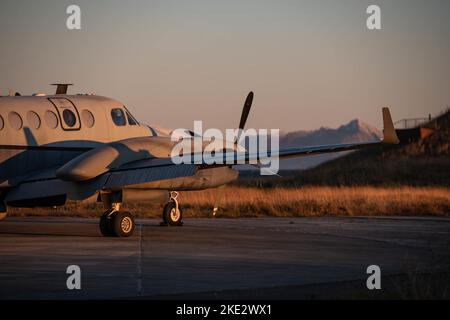 An MC-12W aircraft assigned to the 137th Special Operations Wing, Oklahoma Air National Guard, rests on the flightline after conducting manned intelligence, surveillance and reconnaissance for a live-fire demonstration during ATREUS 22-4 at Andøya Space Defense Range, Norway, Nov. 9, 2022.  This is the first time Rapid Dragon, a precision munitions capability for medium-sized or larger cargo aircraft that allows U.S. and NATO forces a flexible rapid response option, has been employed in the U.S. European Command theater. (U.S. Air National Guard photo by Tech. Sgt. Brigette Waltermire) Stock Photo